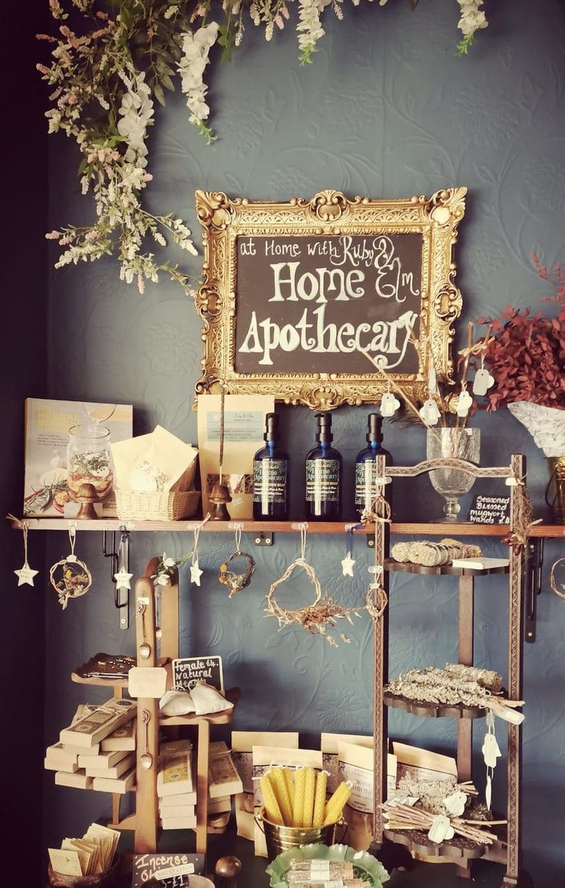 Ruby & Elm 'At Home with Ruby & Elm Home Apothecary' chalkboard sign above the boutique display