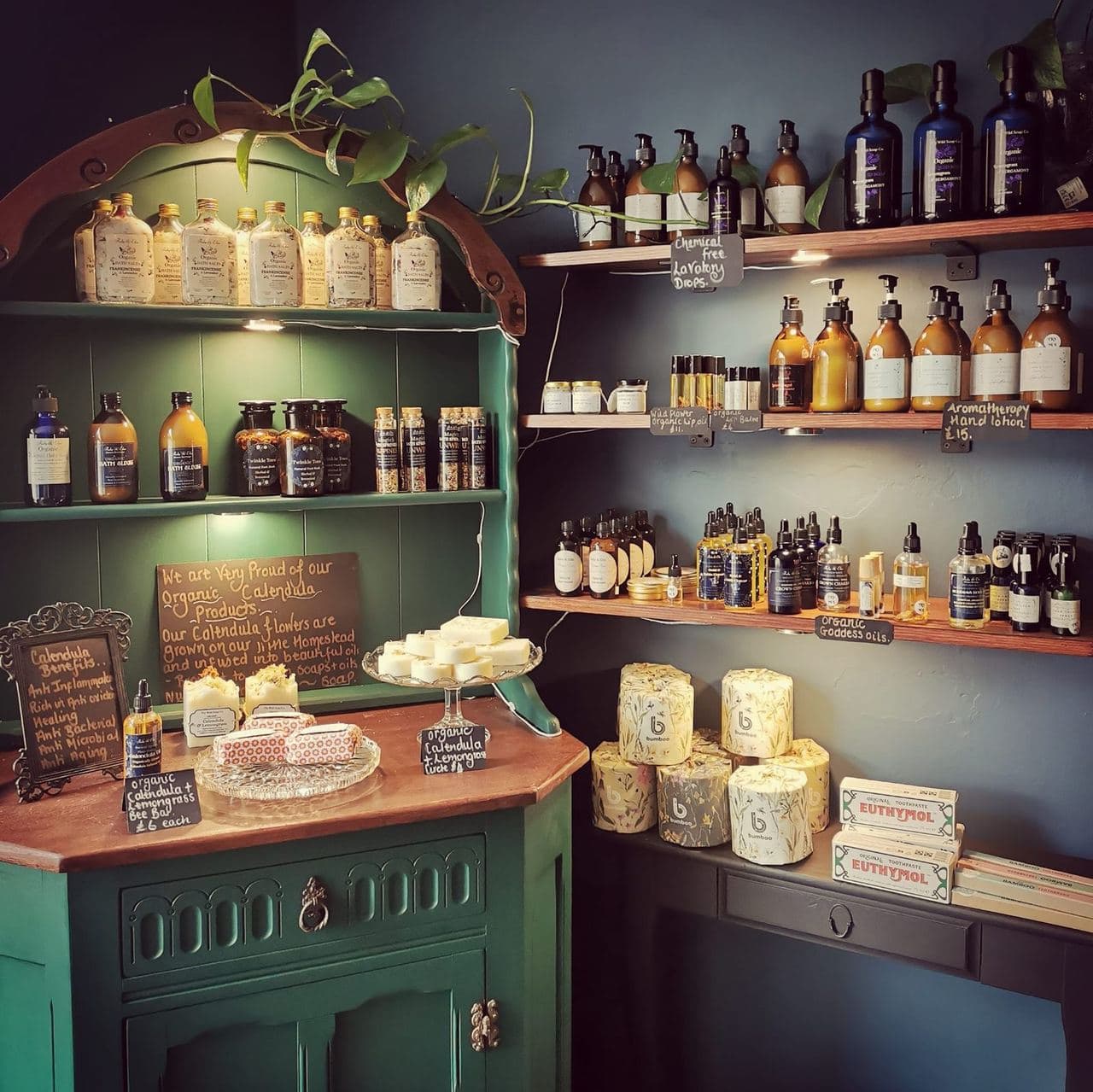 Organic calendula products and natural skincare on the green apothecary dresser
