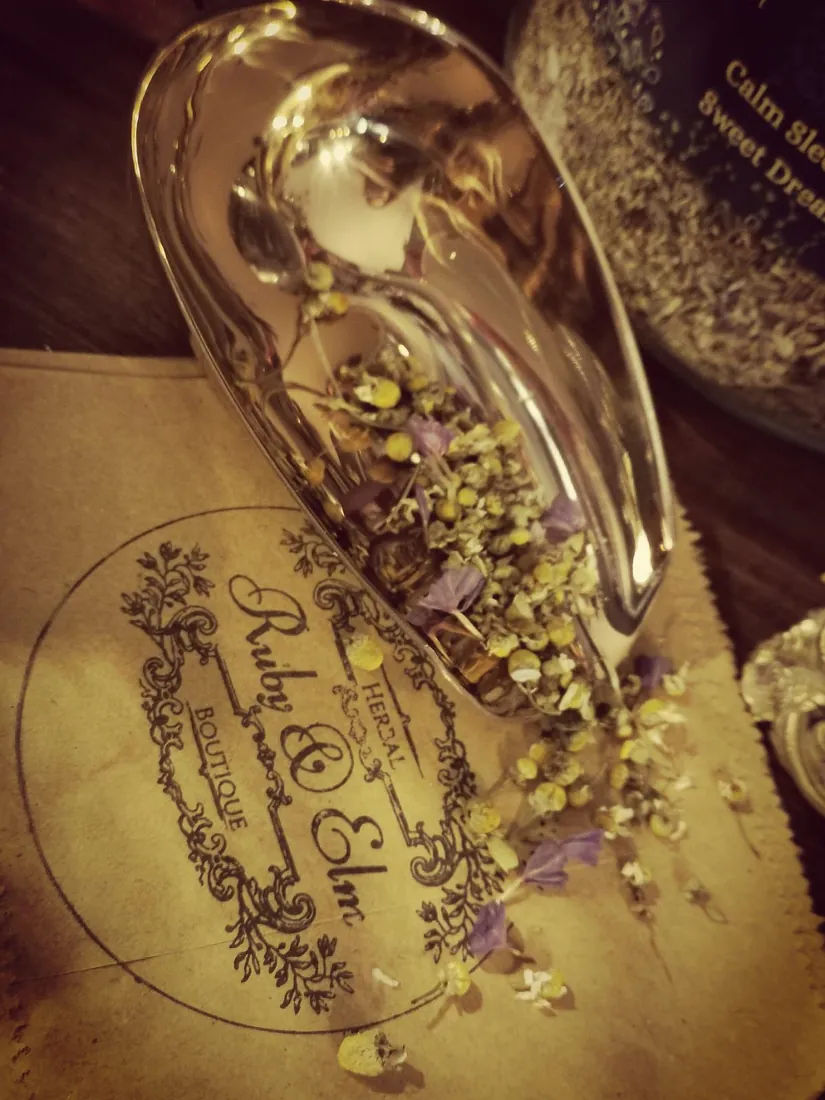 Camomile flowers in the brass scoop on a Ruby & Elm stamped paper bag